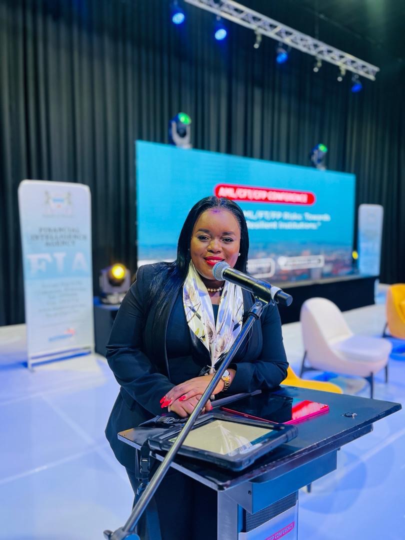 Segolame Thaga hosting at a lectern with a microphone on a conference stage