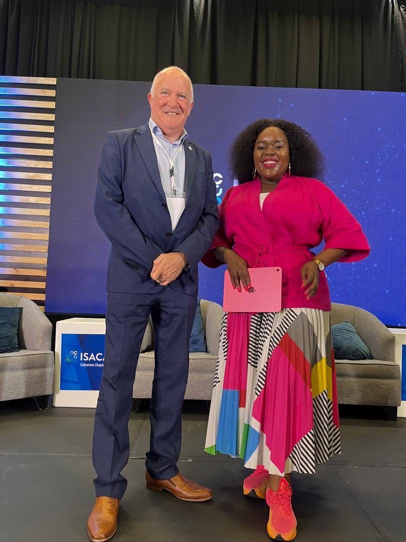 Segolame Thaga in a pink top with a guest at a conference