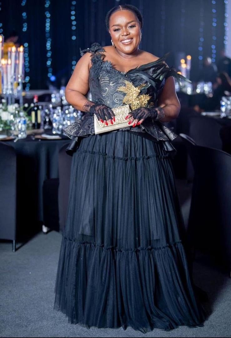 Segolame Thaga in a black evening gown at a formal dinner