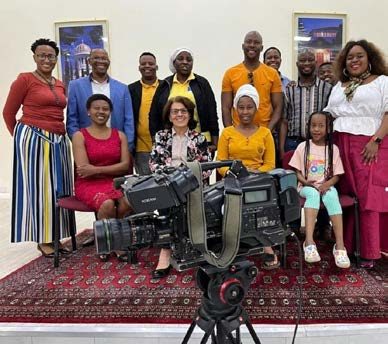 Segolame Thaga with a group of guests and a television camera