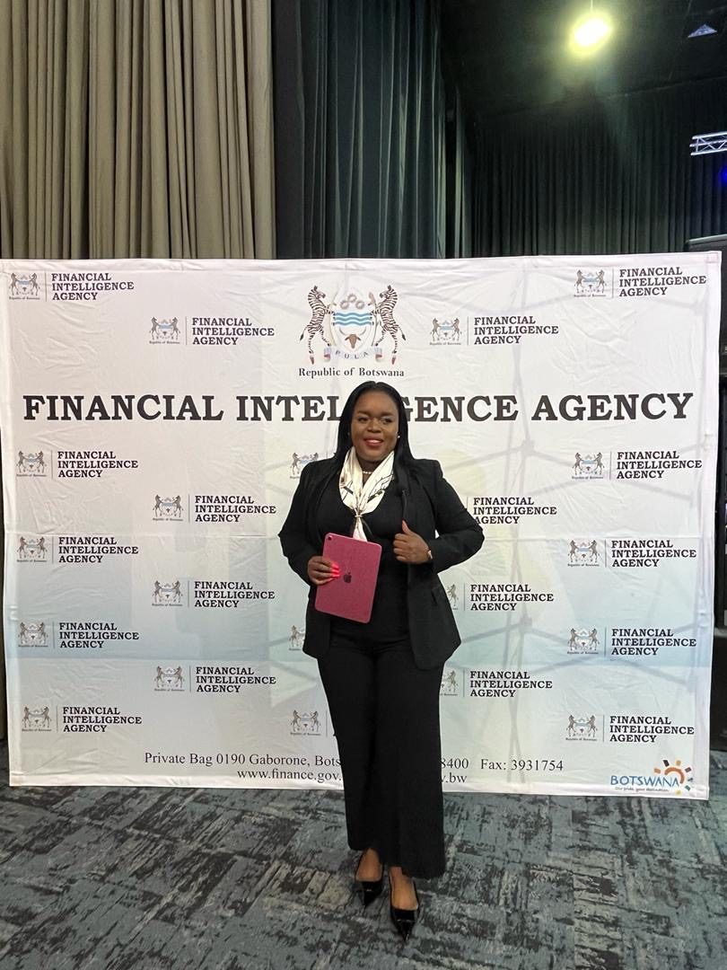 Segolame Thaga in a black suit in front of a Financial Intelligence Agency backdrop
